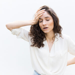 Exhausted tired woman with closed eyes touching head